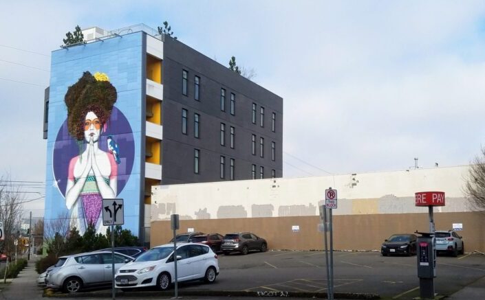 Parking 1 Recommended parking lot located next to blue & purple geisha mural