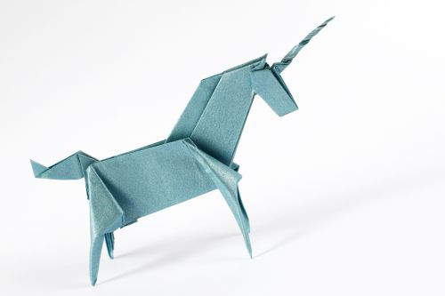 Folded origami unicorn made with blue paper.